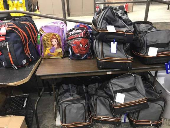 Rotary Club members filled 25 backpacks with basic necessities