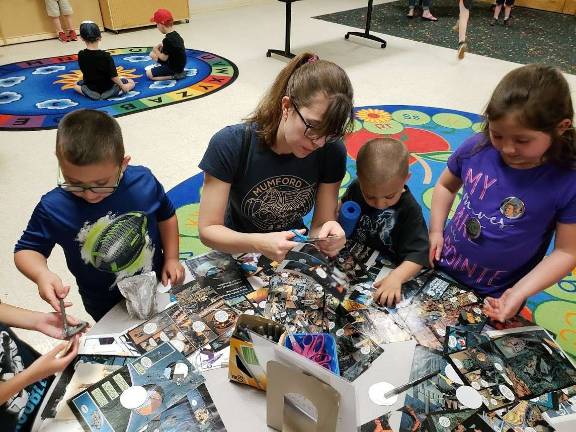 Devore Family: (From left to right) Strider, Julia (step-mom), Brody, and Ella create buttons with images of their favorite Star Wars characters.