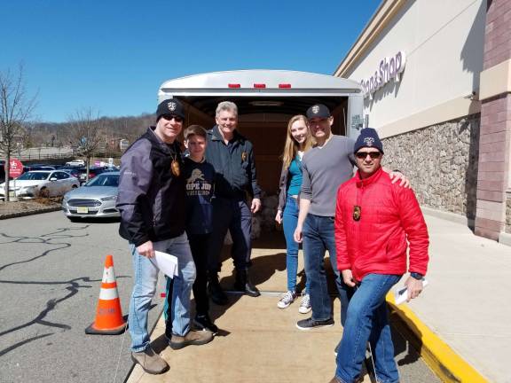 Family and friends help out Sparta's finest on March 31 at Stop &amp; Shop. From left, Det.Lt. Terrence Mulligan,Charlie Mulligan, Lt. John Lamon, Jamie Synder, Recruit John Poon and Sgt. Rob Fraser