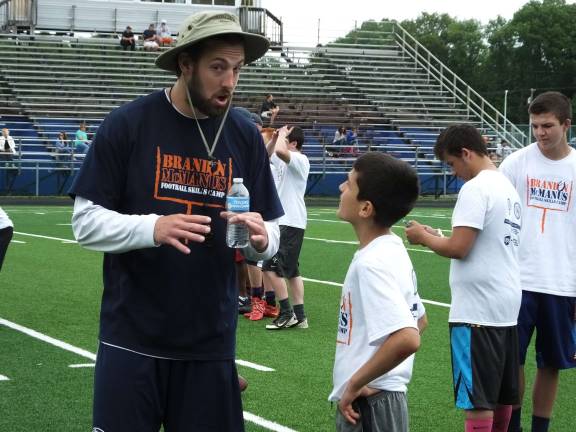 Former Tennessee Titans tight end Brett Brackett speaks to a young athlete.