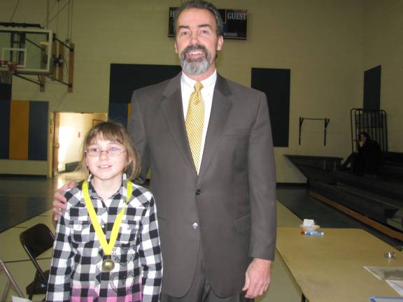 5th grader Kaitlyn Verney,of Sparta, winner of Northwest Christian School&#x2019;s Geography Bee Competition, with Joseph M. Cottrell, Principal.