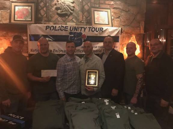 From left; West Milford Police Officer Matt Kloo, Jefferson Police Officer Brian Seeley, Sparta Police Sgt. Rob Fraser, Mohawk House owner Steve Scro holding a plaque for community service presented to him by the Sparta VFW, VFW member John Finkeldie, West Milford Police Officer Nick Snook and Sparta VFW Commander Pete Litchfield