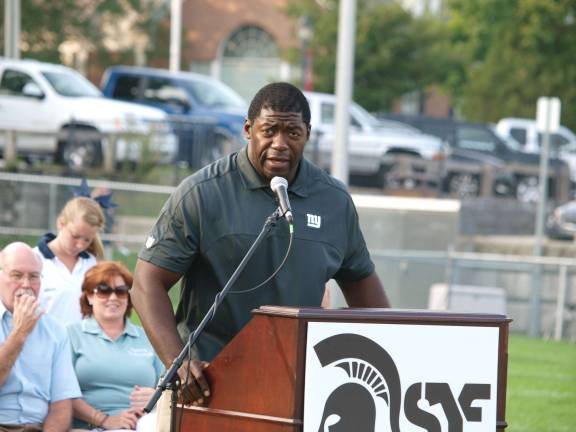 Former professional football player Roman Oben speaks. Oben was among the special guest speakers. Football fans packed Ungerman Field in Sparta, N.J. on Friday August 30, 2013. Sparta youth teams took on several teams from neighboring towns in exhibition games. The evening also featured a special recognition of military veterans.