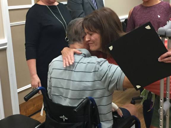 Monica Transier greets Tom Heller with a hug. Photos by Laurie Gordon