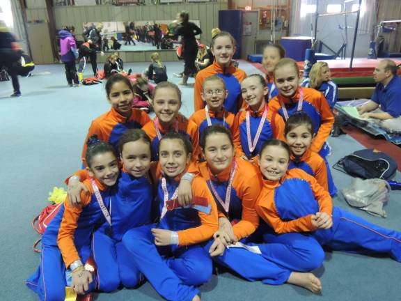 Copper and bronze Gators celebrate together after the meet.
