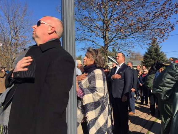 Attendees, hand-to-heart, at the Sparta Veterans Day ceremony on Nov. 11, 2018.