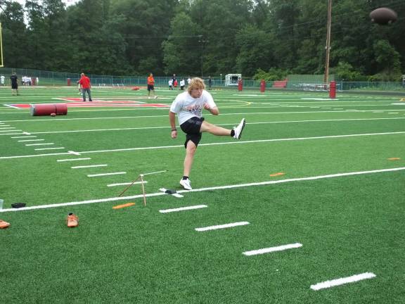 Sixteen-year-old Kevin Utter kicks the football during a practice session.