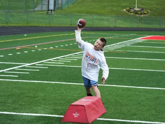 Seven-year-old Matthew Akerman, of Byram, throws a football.