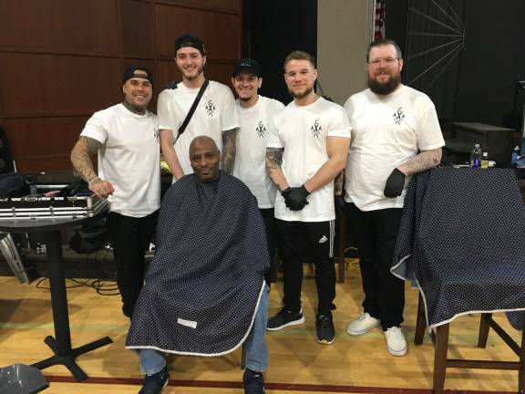 From left, standing: ‘A Cut Above’ Barbershop owner Gelin Suarez, barbers Zack Kronenfeld, Manny Galicia, Eric Horn and Chris Bassani. Seated is ‘Army Strong’ Veteran Mac Davis