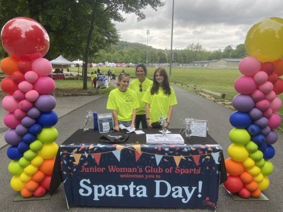 Haley Erikson, left, and Elise Uitdenhowden, right, are Sparta High School Key Club members. They are standing with Kate Palmer, a member of the Junior Woman’s Club of Sparta, which organizes Sparta Day.