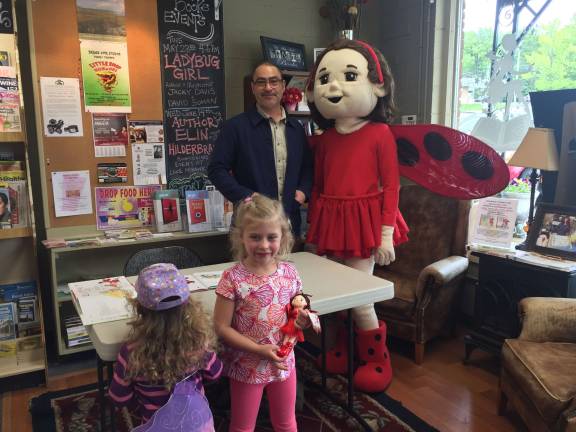 Author David Soman stops at Sparta Books with a special guest Ladybug. Two young readers look on sisters Gracie and Kyla Bitondo. Photos by Rose Sgarlato
