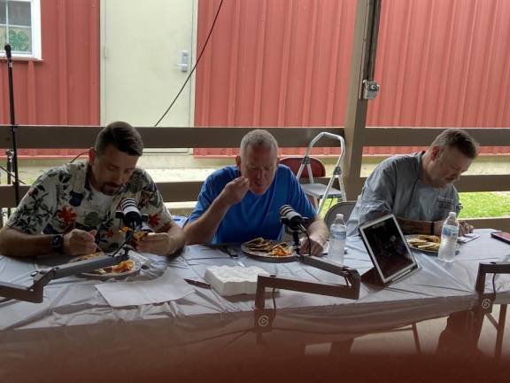 The judges, from left, Ben DelCoro, Ken Salmon and Gregory Martin taste the entries.