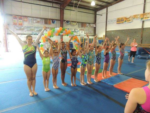 Members of the Sparta Garden Gator team and prep team perform at a recent fashion show.