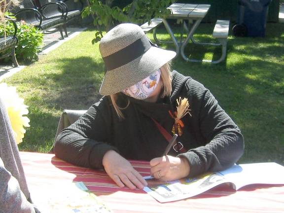 Book illustrator Sue Struble autographs the fun book (Photo by Janet Redyke)
