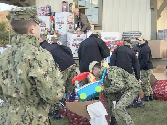Donated toys are loaded onto the Toys for Tots train at the Sparta station in December 2022. (File photo by Kathy Shwiff)