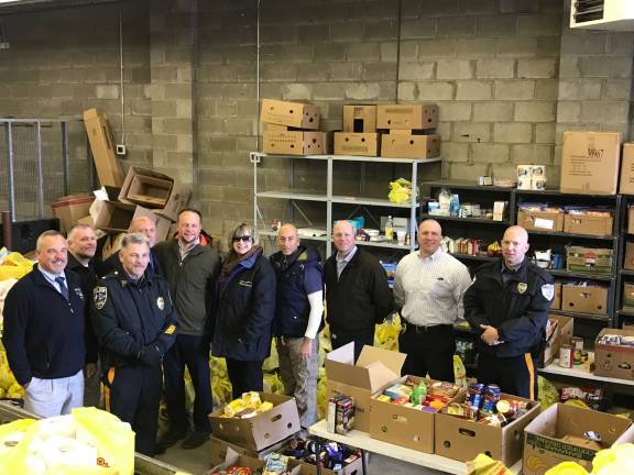 At the shipping point. From left, Sparta PD Det. Keith Hannam, Byram PD Lt. Ken Burke, Sparta PD Lt. John Lamon, Byram Police Chief Pete Zabita, Sparta Police Chief Neil Spidaletto, Director of Sussex County Food Pantry Carol Novrit, owner of Mohawk House Steve Scro, Sparta PD Det. Lt. Terrence Mulligan, Sparta PD Det. Brian Hassloch and Andover PD Officer Rich Then.