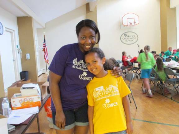 Janelle Daly, the program's coordinator, poses with her daughter, Emma, who embraced helping her mother throughout the week.