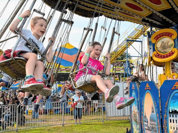 <b>Fair-goers ride the swings Saturday, Aug. 2. (Photo by Denise von Wilke)</b>