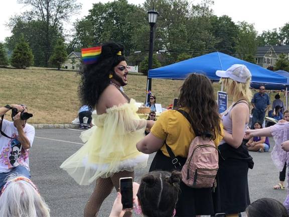 A drag performer greets those attending the Pride Celebration.