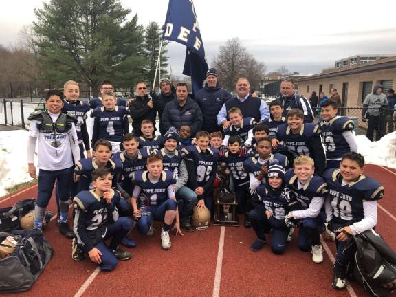 The Pope John Jr Lions 11U football team poses for a photo after winning the American Youth Football Big East Regional Championship on Nov. 18 by beating the New Rochelle (N.Y.) Huguenots, 20-6, in the title game at Mahopac High School in Mahopac, N.Y. (Photo provided).