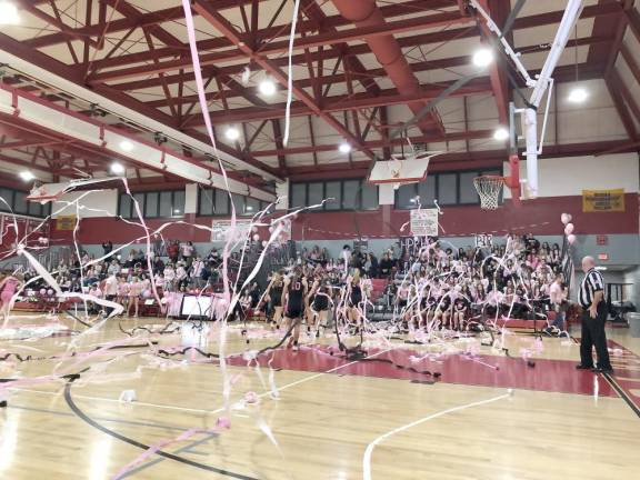 The crowd throws streamers after the first basket is scored during the Pretty in Pink varsity girls basketball game at High Point Regional High School on Saturday, Jan. 14.