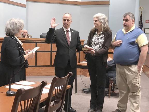 Sparta Councilman Daniel Chiariello is sworn in for a new four-year term by Roxanne Landy, left, deputy registrar/clerk. With him are his wife, Lia, and brother Roy.