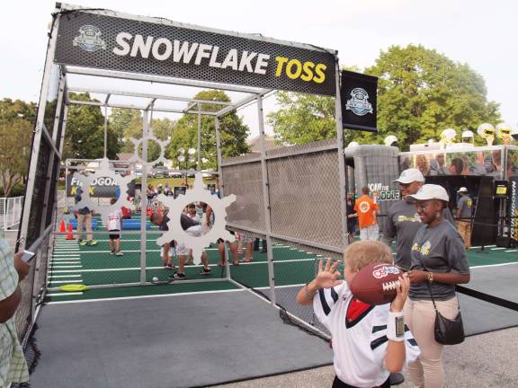 A participant takes aim in the snowflake toss. Football fans packed Ungerman Field in Sparta, N.J. on Friday August 30, 2013. Sparta youth teams took on several teams from neighboring towns in exhibition games. The evening also featured a special recognition of military veterans.