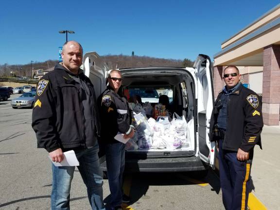 Sgt.Frank Schomp, Cpl.Rick Smith and Cpl.Mark Mastandrea of Sparta PD help out at Saturday's Cram the Cruiser food collection. Photos by Rose Sgarlato