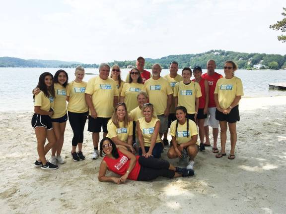 Pass It Along Volunteers: Back Row Left to Right: Carissa Sing, Rachel Young, Sydney Vanbrunt, Tom Fitzpatrick, Vicky Peters, Elaine Fitzpatrick, President Kurt Walton, Steve Matychick, Jerry Covell, Noel Abrams, Andrew Krops and Beth Walton. Front Row Left to Right: Patty Askin, Karen Baldini, Dawn Scott, Charlotte Pagliaro. Front: Finance Director and Event Coordinator Eleanor Young.