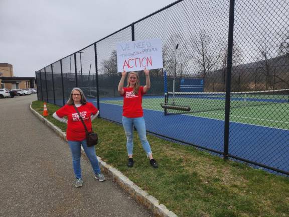 From left, Stacey Heredia and Patty Rivas of Sussex County Moms Demand Action support the students’ walkout.