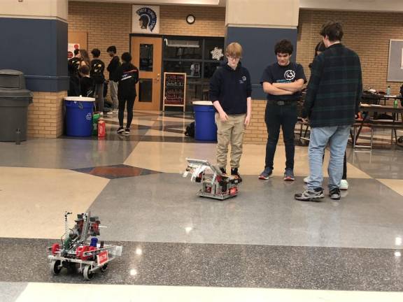Sparta High School robotics team members test their robot during a break in the competition.