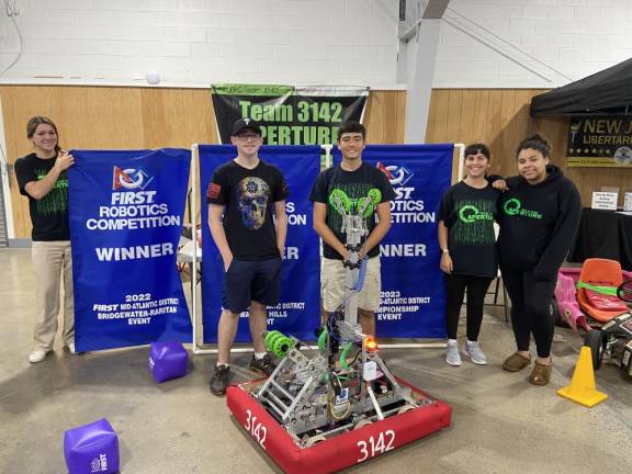 From left are Ciara Roman, coach of the Newton High School robotics team, with team members sophomore Lukas Straub, seniors Felipe Narvaez and Ariel Franzone, and junior Alexis Davis with their robot.