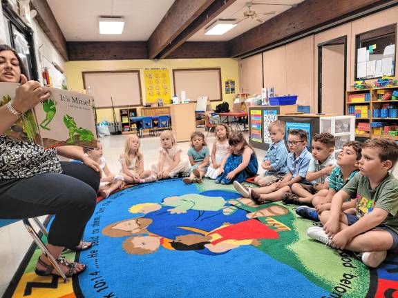 Pre-kindergarten teacher Christine Palmucci reads to the class.