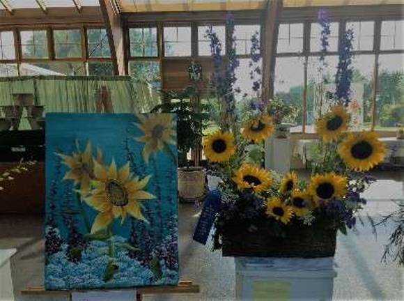 A collaborative category between local art students and professional floral designers yielded this Flower Show 1st place winner. The painting is by Newton High School rising senior Riley Catalano, and the floral interpretation of the artwork is from Petals Florist in Franklin.
