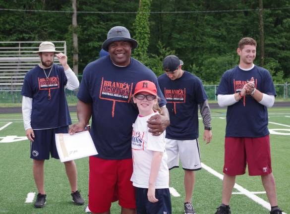 Retired New York Giants running back Lee Rouson with nine-year-old Alaina Campbell, of Hackettstown,