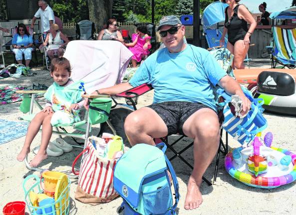 Quinn Rodriguez and Mark Schorr of Lake Mohawk sit in their beach chairs.