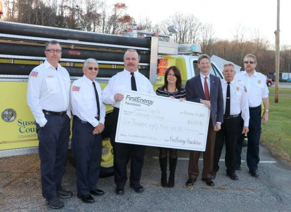 From left, PSTA Instructors James McDonald, John Belli, and William Hendrickson stand next to JCP&amp;L External Affairs Manager Jackie Espinoza as she presents the check to SCCC President Dr. Jon Connolly. PSTA Operations Administrator Larry Bono and Instructor William Hendrickson stand to the right. Photo provided