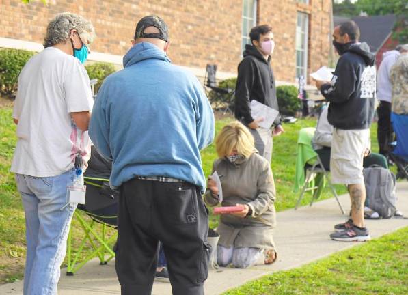 A DMV employee helps someone in line (Photo by Vera Olinski)