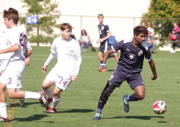 Pope John's Prajith Stephen is in control of the ball.
