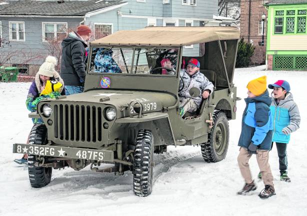 Boy scouts check out a military transport.