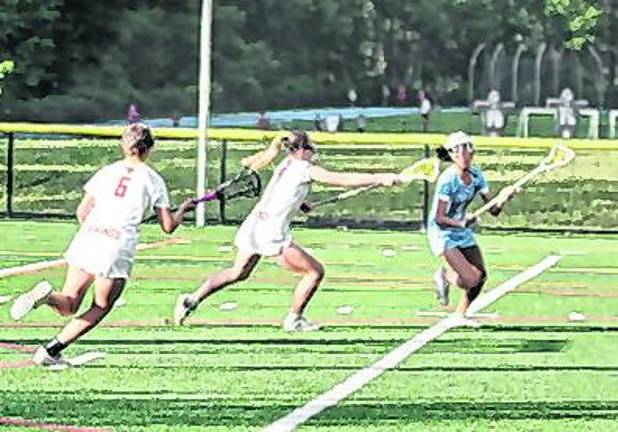 Sparta's Joey Roque carries the ball with her crosse just before a shot attempt in the second period. Roque scored 3 goals.