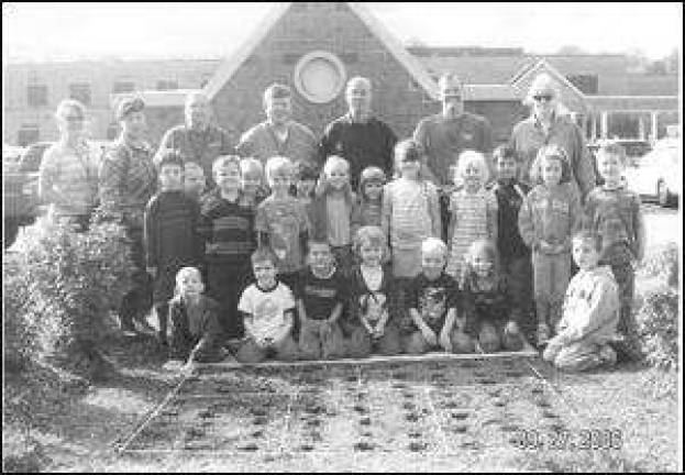 Kindergarten students plant garden for spring season growth
