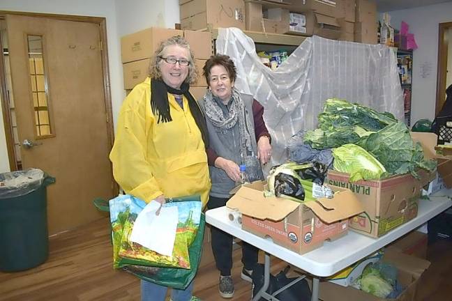 Sandy Suanson, left, who depends on the Sparta Community Food Pantry, stands with volunteer Margy Laplaca.