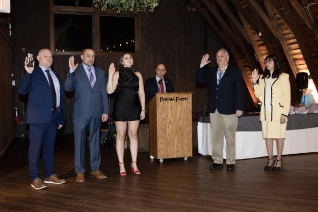 SQ1 New officers and trustees of the Sparta Ambulance Squad are sworn in at the annual installation Jan. 18 at Perona Farms in Andover. (Photos by Dave Smith)
