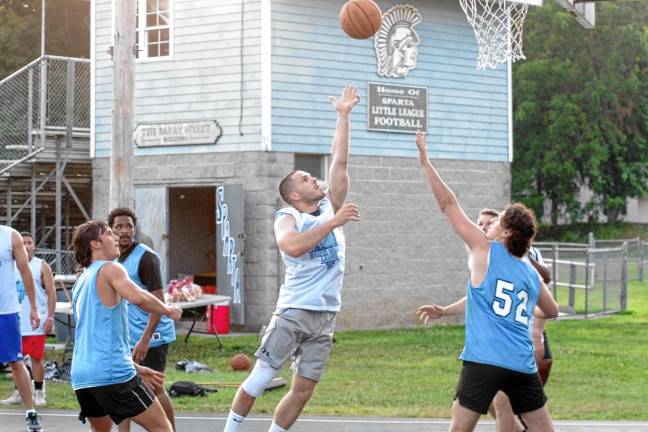 SB2 Team Smalley's Nick Miller tosses the ball toward the hoop in a game against Team Falk.(Photos by George Leroy Hunter)