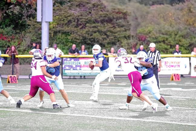 <b>SN2 Sparta quarterback Shane Hoover holds the ball as he scans the field for an open receiver. He threw for 253 yards.</b>