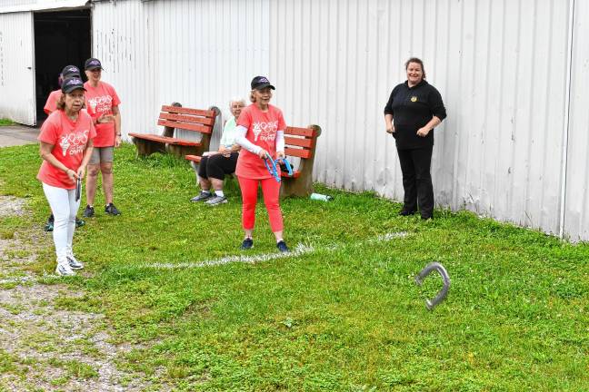 <b>Senior Olympians compete in horseshoes.</b>