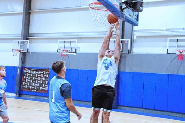 Team Smalley's Almin Hodzic raises the ball toward the hoop. He is a graduate of Mount Olive High School.