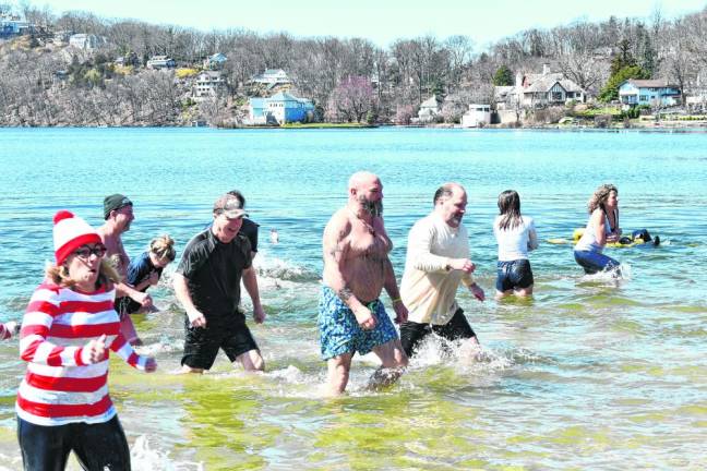 Those who took the plunge head back out of the water. The temperature was 34 degrees at noon Sunday.