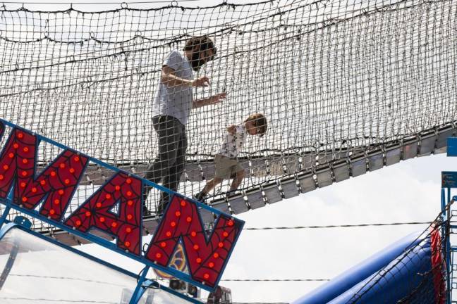 FR30 Erik Knoop of Hampton Township and his son Oliver, 3, make their away across the rope bridge at the New Jersey State Fair on Sunday, Aug. 6. (Photo by John Hester)